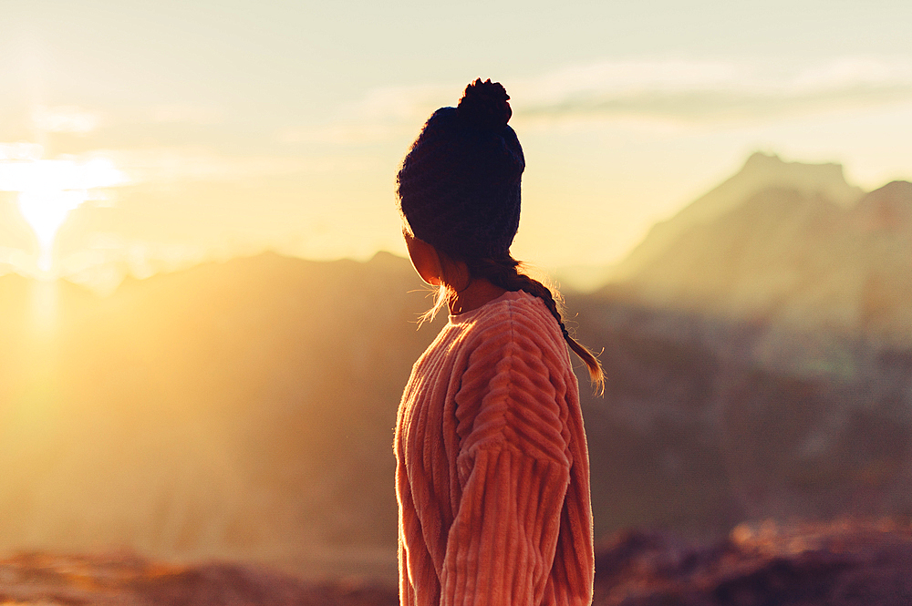 Woman enjoys sunrise in the mountains in Raetikon, Vorarlberg, Austria, Europe