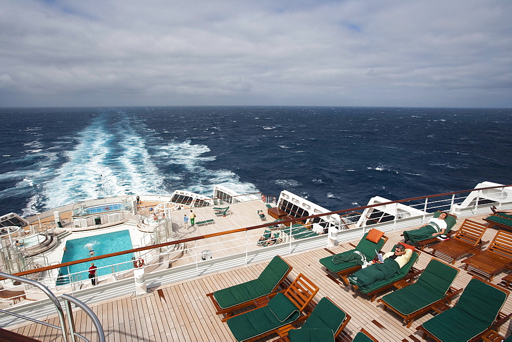 Deck chairs, swimming pool and backwash, cruise ship Queen Mary 2, Atlantic ocean