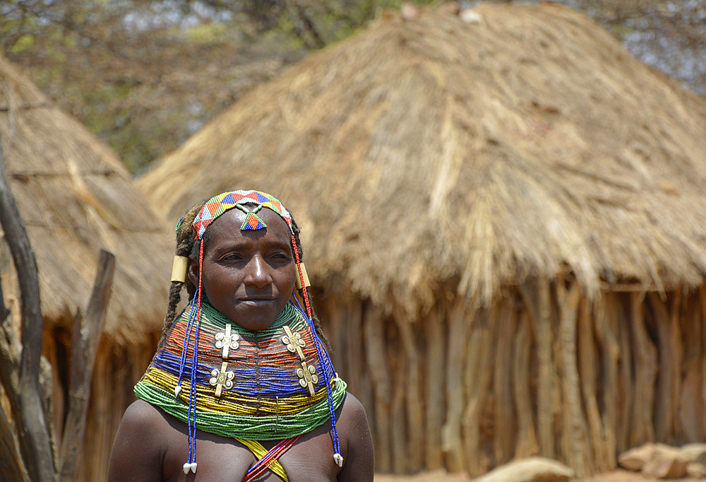 Angola; Huila Province; small village near Chibia; Muhila woman with traditional head and neck jewelry; ornate pearl jewelry in the hair; massive choker made of pearls and earth