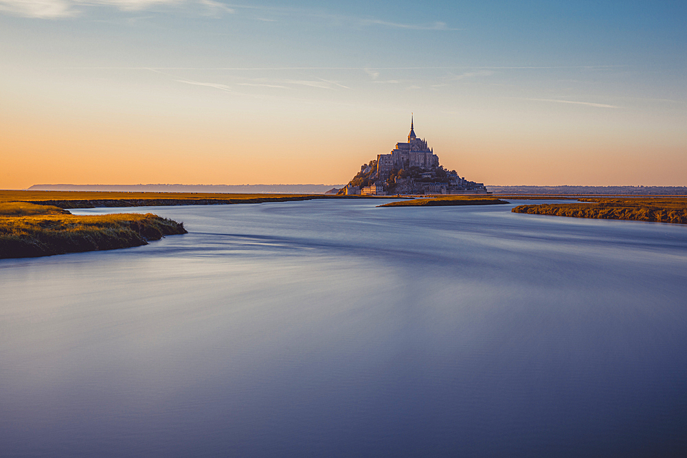 Evening view of the rocky island of Mont Saint Michel with the monastery of the same name, Normandy, France.