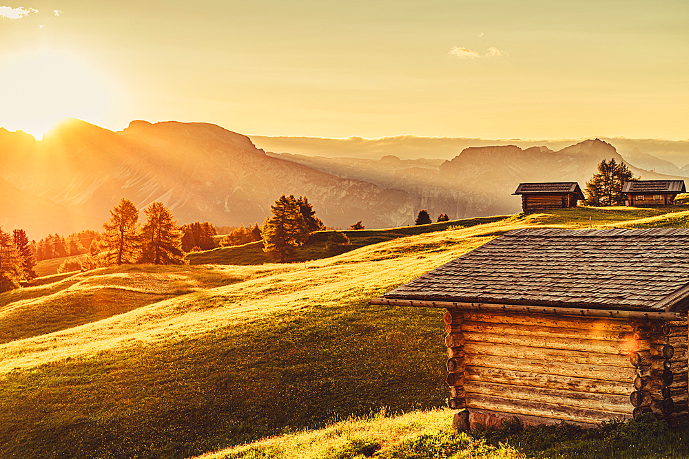 Hut at sunrise on the Seiser Alm in South Tyrol, Italy, Europe;