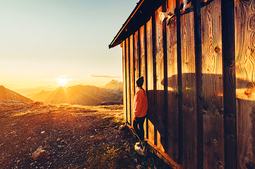 Woman enjoys sunrise in the mountains in Raetikon, Vorarlberg, Austria, Europe