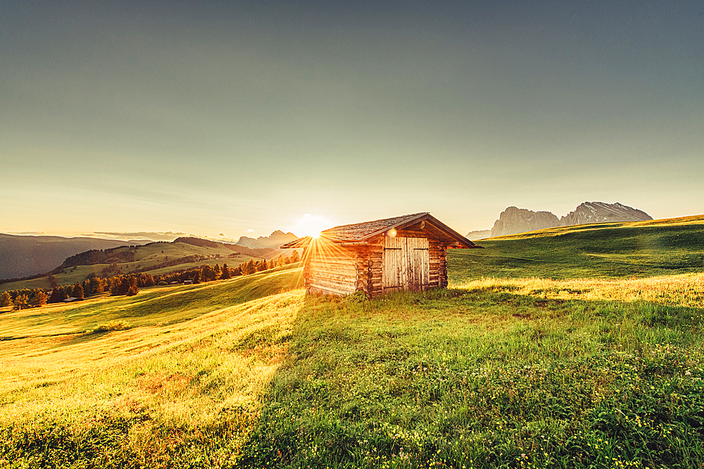 Hut at sunrise on the Seiser Alm in South Tyrol, Italy, Europe;