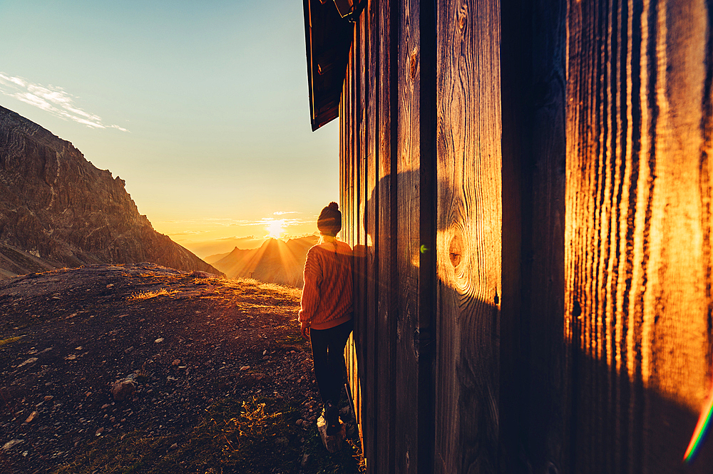 Woman enjoys sunrise in the mountains in Raetikon, Vorarlberg, Austria, Europe