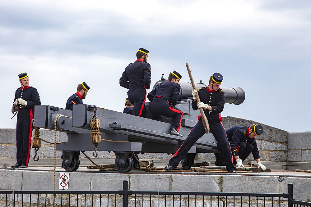 Firing historic cannons at Fort Henry Historic Site and Museum of Living History with uniformed performers known as the Fort Henry Guard performing British military life demonstrations and tours for visitors, Kingston, Ontario, Canada, North America