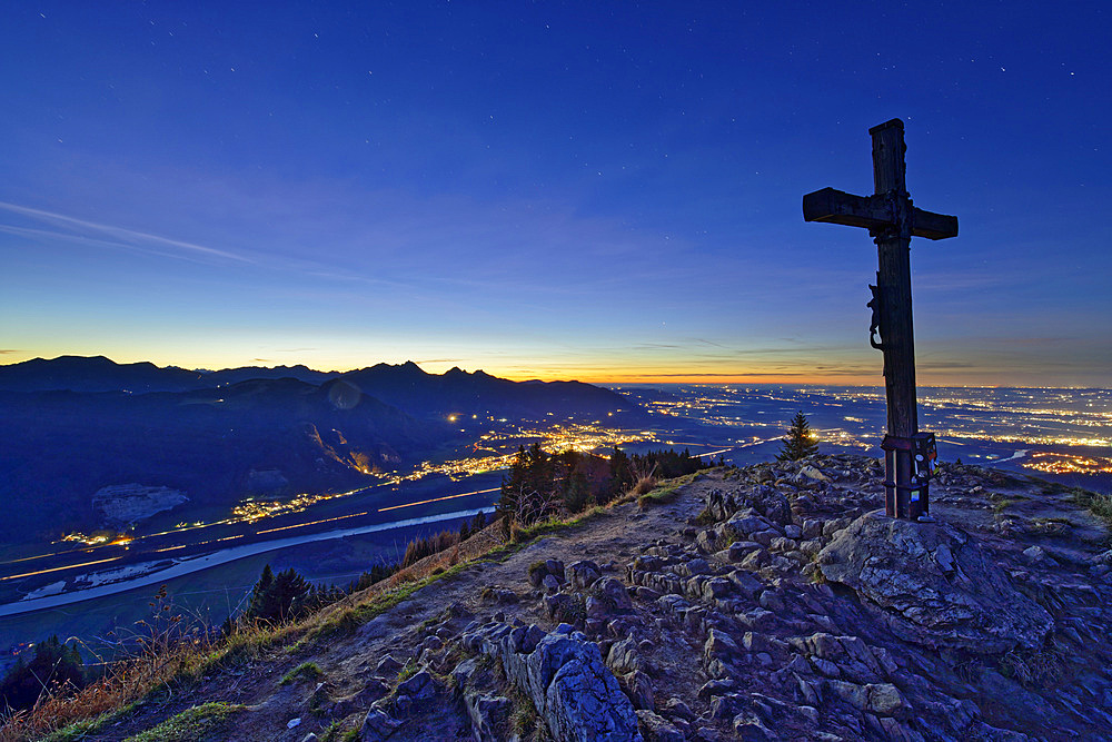 Night mood on the Heuberg with summit cross and deep view of the Inn Valley and illuminated places of the Rosenheimer Land, Heuberg, Chiemgau Alps, Upper Bavaria, Bavaria, Germany