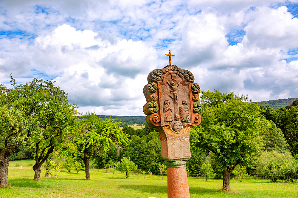 Wayside shrine with crucifixion scene in Findlos, view of the Rhön landscape