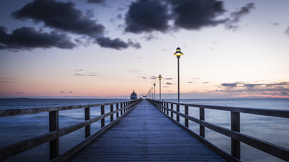 Long exposure at the pier in Zinnowitz on Usedom in the blue hour at sunrise, Germany, Mecklenburg-Western Pomerania, Baltic Sea