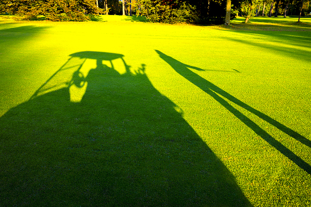 Shadow of Golfer and Golf Cart on Golf Course in Lugano, Switzerland.