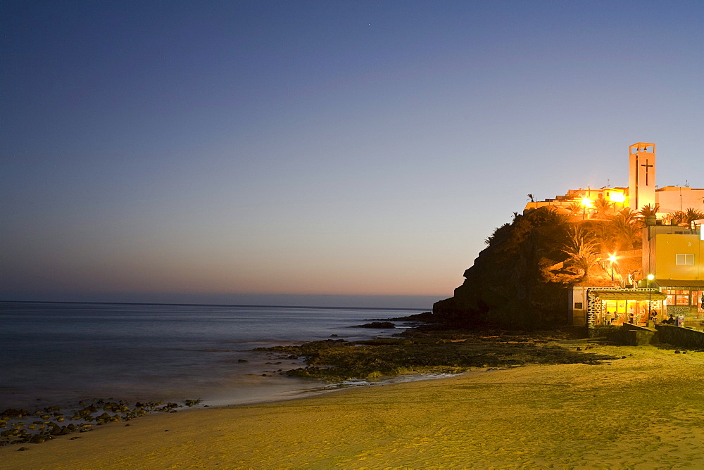 Illuminated restaurant at the beach at dusk, Morro Jable, Jandia peninsula, Fuerteventura, Canary Islands, Spain, Europe