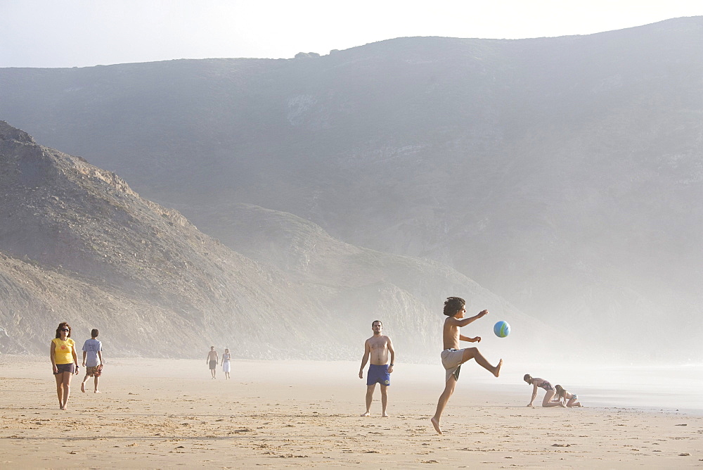 Children playing football on the beach, Praia do Castelejo, Vila do Bispo, Algarve, Portugal