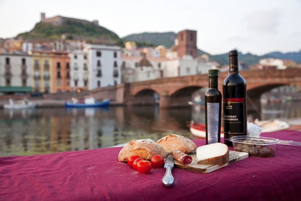 Picnic at the river Fiume Temo with view to the Castello di Serravalle, Bosa, Sardinia, Italy, Europe