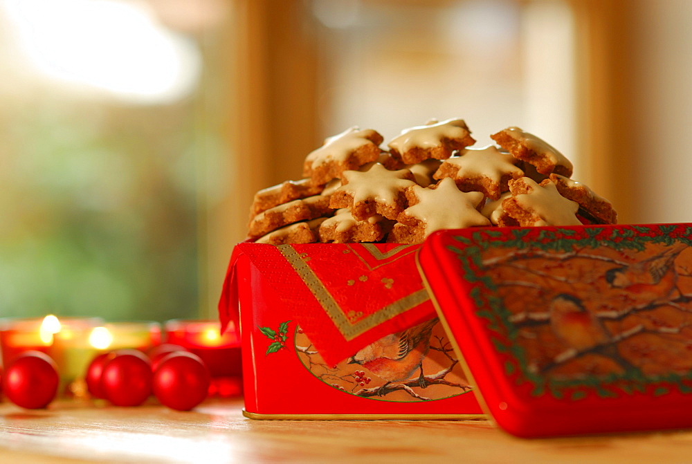 Christmas cookies cinnamon stars piling up in Christmas tin