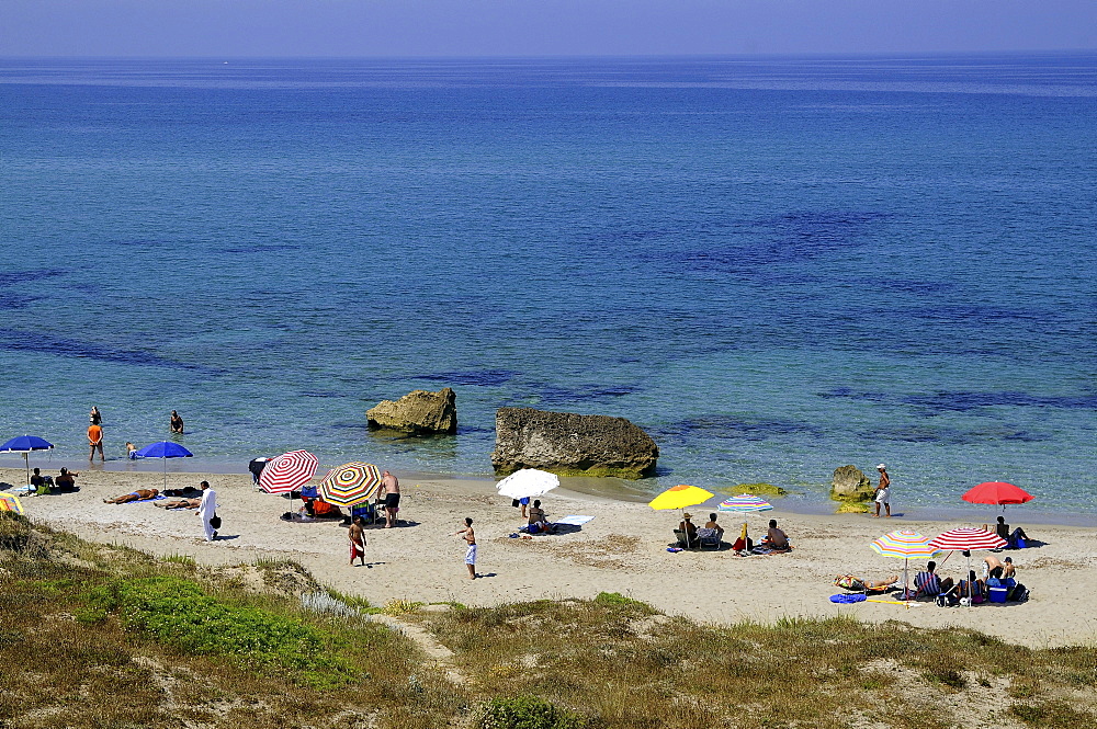 Colourful sunshades and people on the beach, Sardinia, Italy, Europe