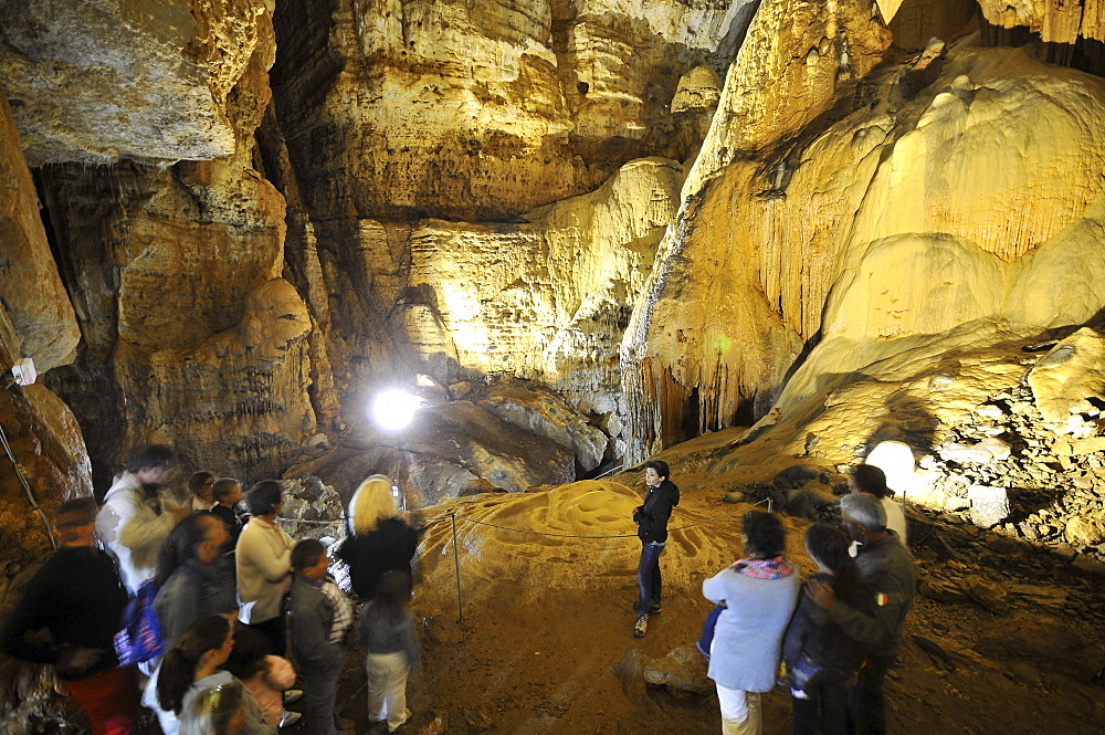 Tourists at the illuminated cave Grotta su Marmuri in the Gennargentu mountains, Sardinia, Italy, Europe