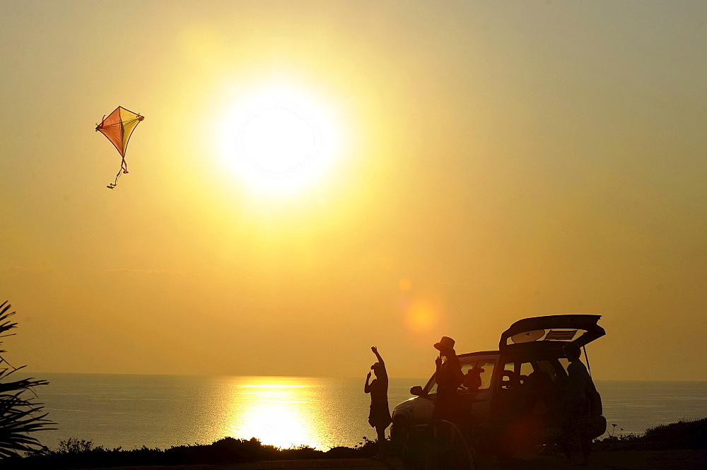 Kiteflying at Capo Sandalo at sunset, Isola di San Pietro, South Sardinia, Italy, Europe