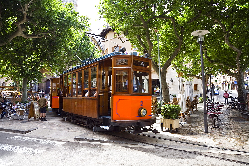 Nostalgic train Red Flash beneath some trees at SÃ›ller, Mallorca, Balearic Islands, Spain, Europe