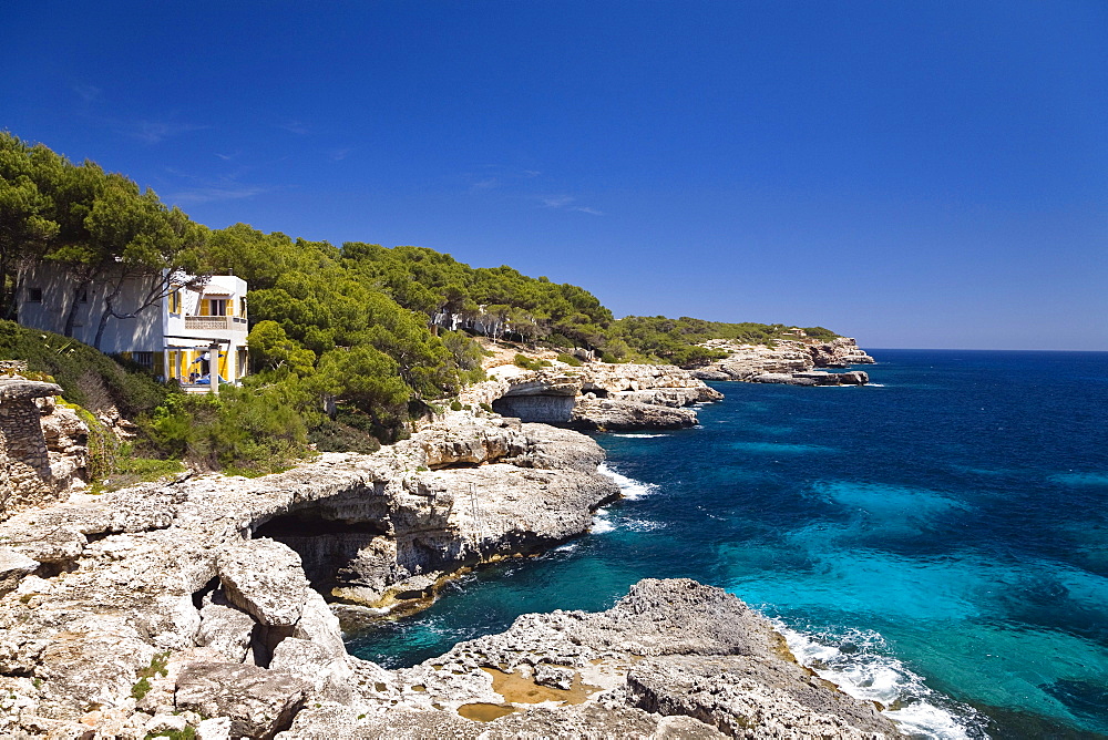 Cliffs in the bay Cala MondragÛ under blue sky, natural park of MondragÛ, Mallorca, Balearic Islands, Mediterranean Sea, Spain, Europe
