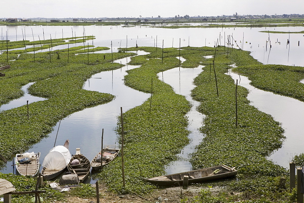 Water canals and boats under clouded sky south of Phnom Penh, Cambodia, Asia