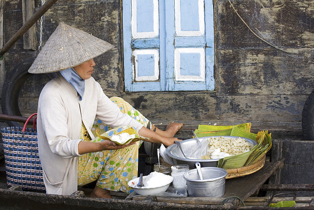 Floating Market, woman in a boat on the Mekong River at Tra On, Mekong Delta, Can Tho Province, Vietnam, Asia