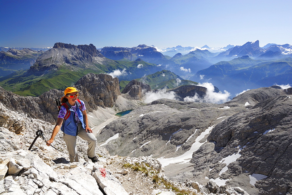 Woman ascending to mount Kesselkogel, Rosengarten group, Dolomites, Trentino-Alto Adige/South Tyrol, Italy