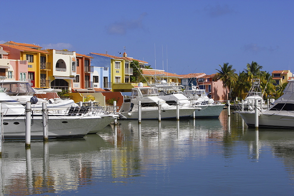 Boats are moored at Palmas del Mar harbour in front of colourful houses, Palmas del Mar, Puerto Rico, America