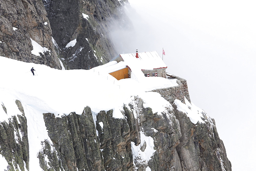 Mountain lodge Cabane de l'A Neuve in fog, Val Ferret, Canton of Valais, Switzerland