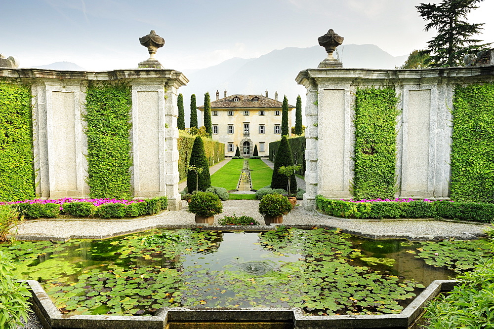 Fountain and garden with villa at Lake Como, Lombardy, Italy