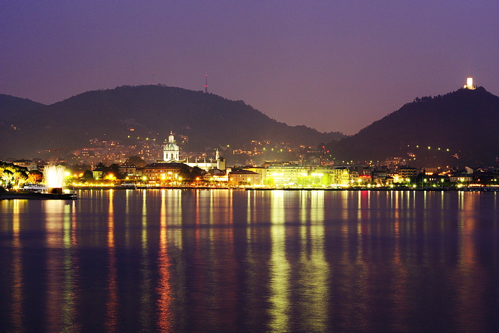 View over Lake Como to Como at night, Lombardy, Italy