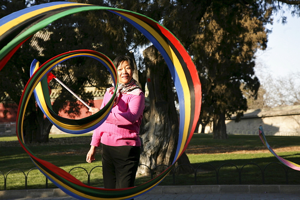 Chinese woman doing gymnastics at Tiantan Park, Beijing, Peking, China, Asia