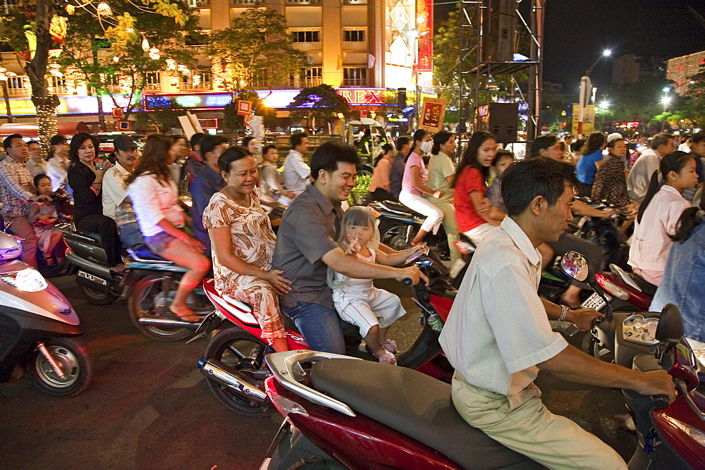 People driving scooters during the Tet festival at night, Saigon Ho Chi Minh City, Vietnam, Asia