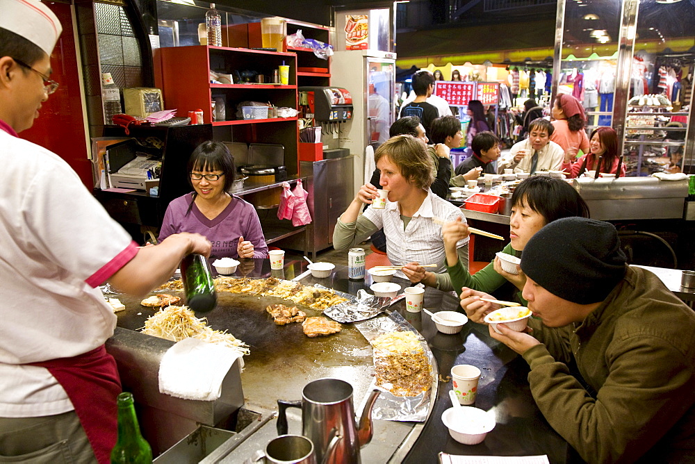 People in a Teppanyaki restaurant at Shilin night market, Taipei, Taiwan, Asia