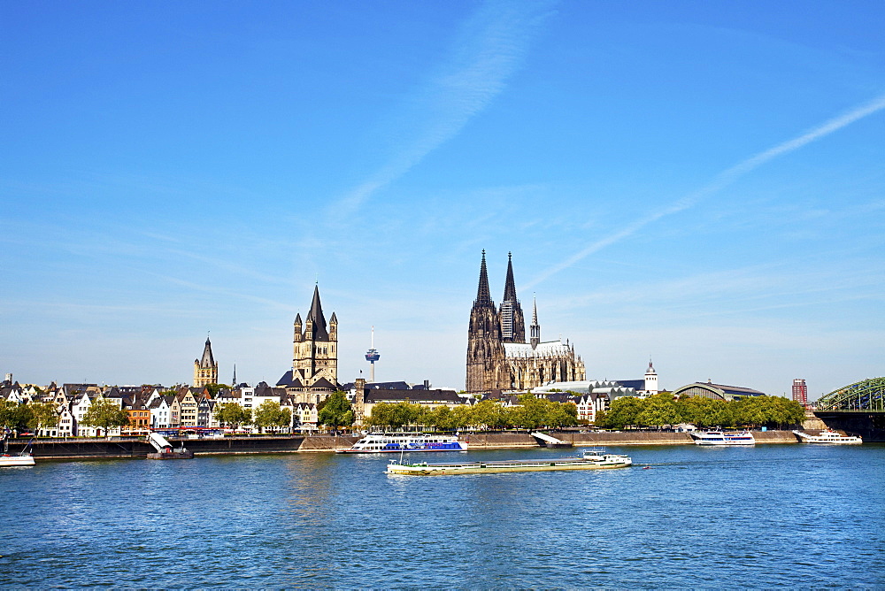 View over rive Rhine to old town with cathedral and Great St. Martin church, Cologne, North Rhine-Westphalia, Germany