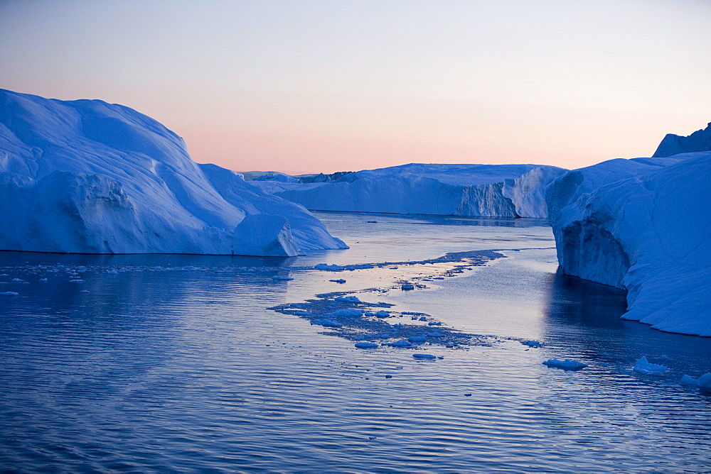 View at icebergs from Ilulissat Kangerlua Icefjord at dusk, Ilulissat (Jakobshavn), Disko Bay, Kitaa, Greenland