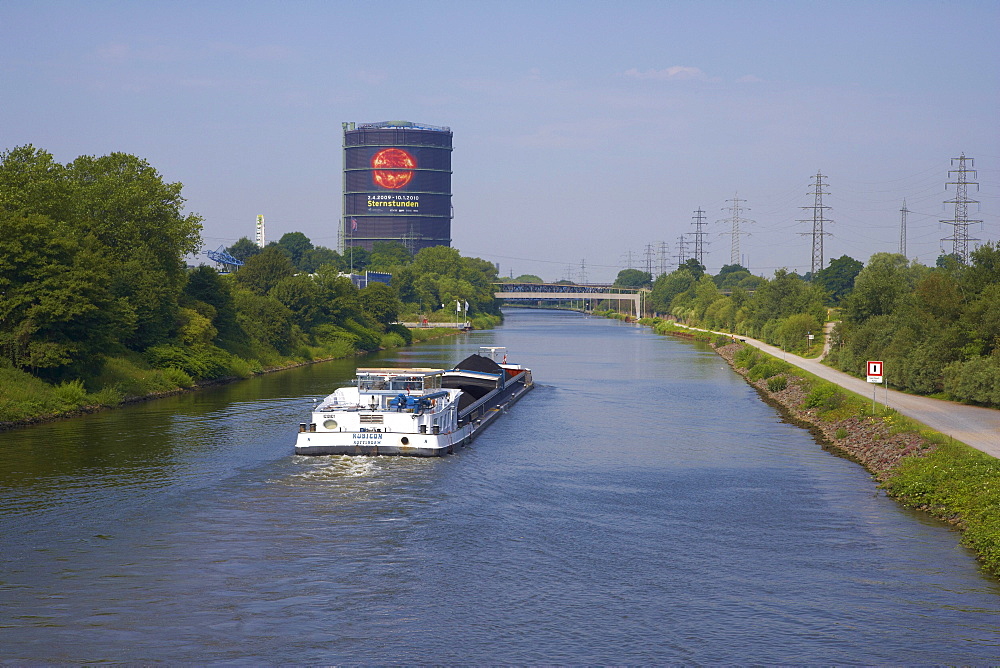 Oberhausen Gasometer with river Rhine-Herne-Canal and lighter, Oberhausen - Neue Mitte, Ruhrgebiet, North Rhine-Westphalia, Germany, Europe