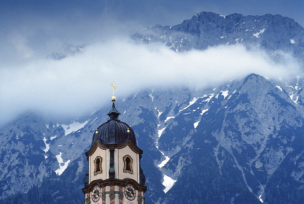 Church steeple with the Karwendel mountain range in the background, Church of St. Peter and Paul, Mittenwald, Karwendel Mountains, Bavaria, Germany