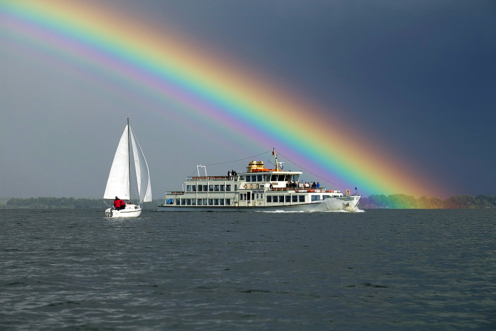 Sailing boat and ferry with rainbow, Lake Chiemsee, Bavaria, Germany