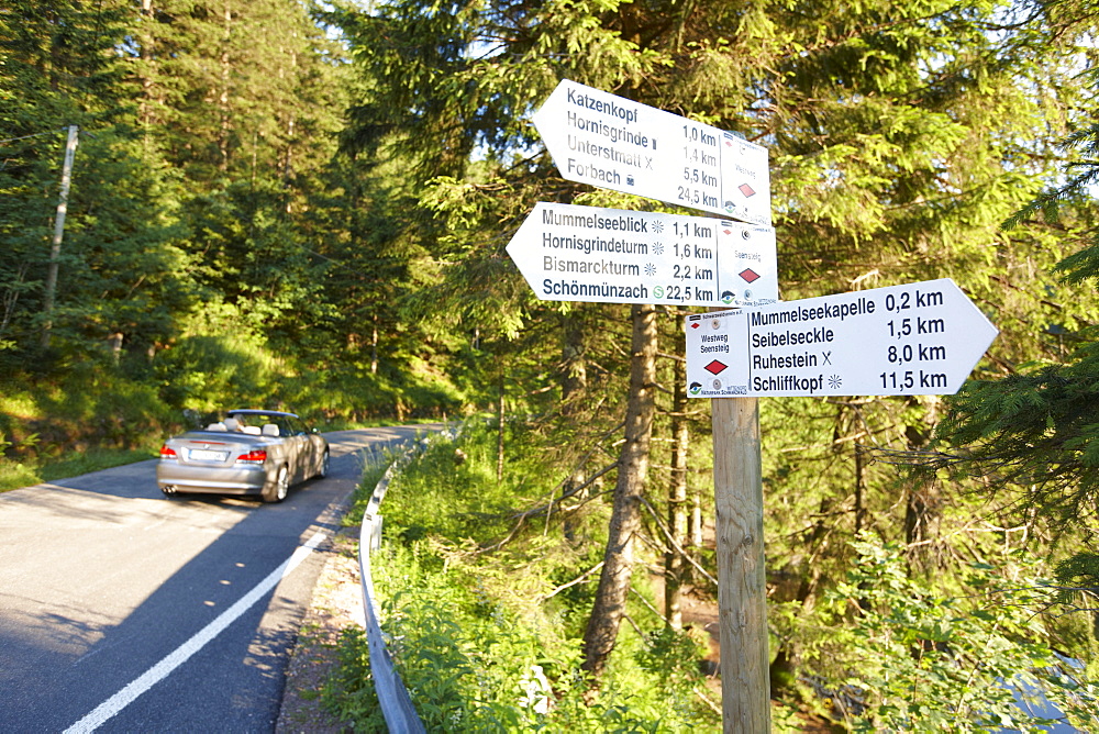 Convertible passing road near Lake Mummelsee, Seebach, Black Forest, Baden-Wuerttemberg, Germany