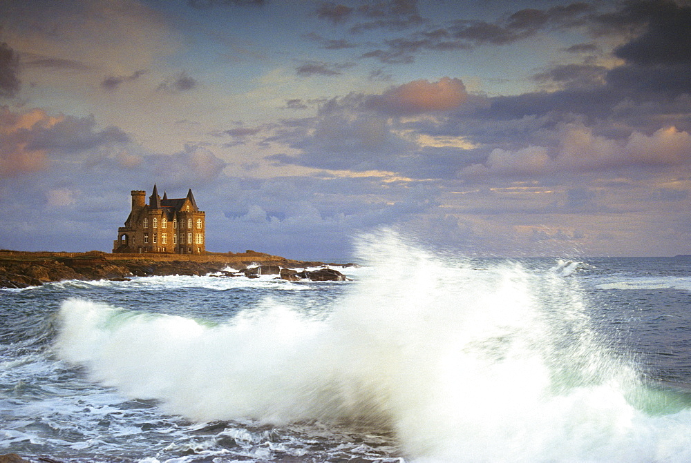 The surge and Chateau Turpeau in the light of the evening sun, Cote Sauvage, Quiberon, Brittany, France, Europe