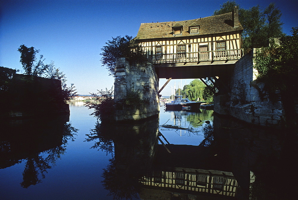 Old mill at the Seine river under clouded sky, Normandy, France, Europe