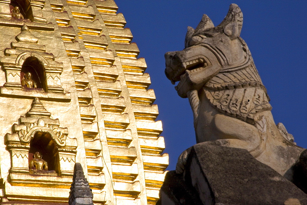 Animal figure in front of a Pagode with golden Stupa in Bagan, Myanmar, Burma