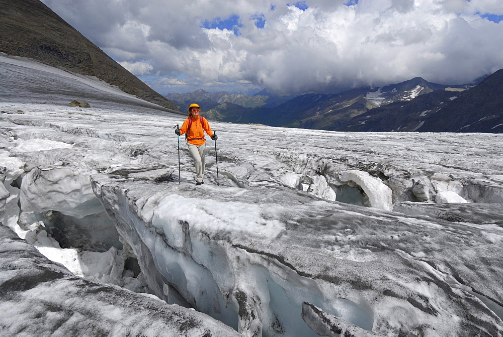 young woman between crevasses on glacier Bockkarkees, Hohe Tauern range, National Park Hohe Tauern, Salzburg, Austria