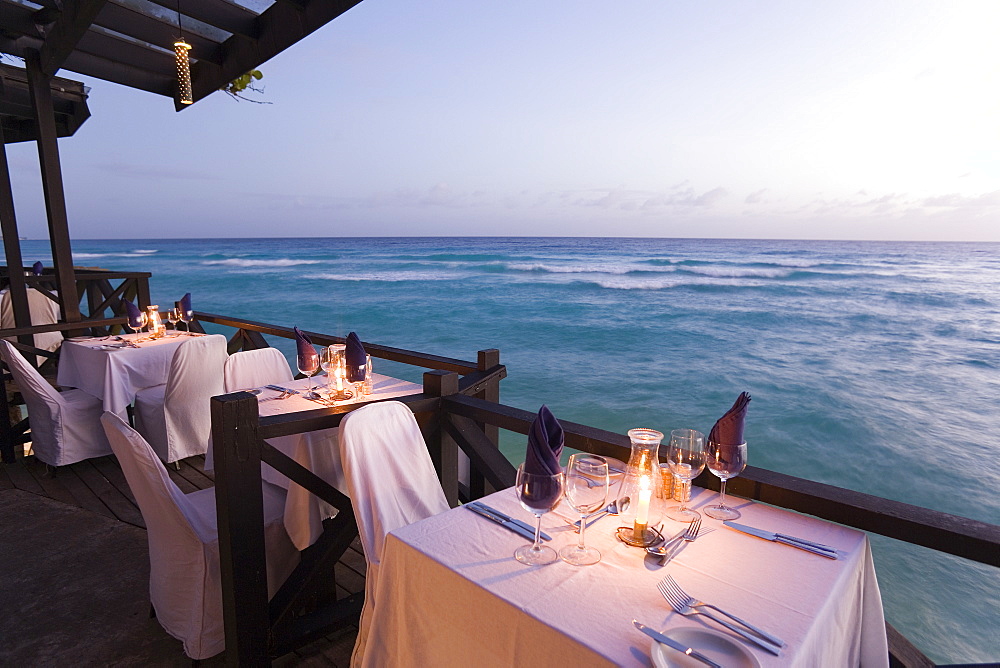 Terrace by the water's edge in the evening of the restaurant Josef's, St. Lawrence Gap, Barbados, Caribbean