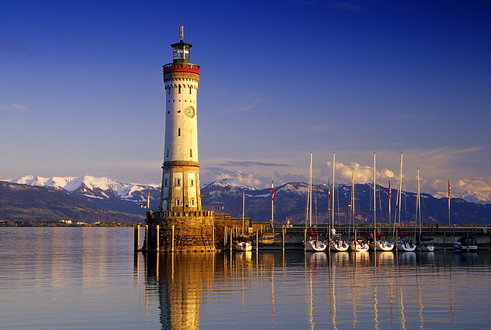 Lighthouse at harbour in front of snow covered Alps, Lindau, Lake Constance, Baden Wurttemberg, Germany