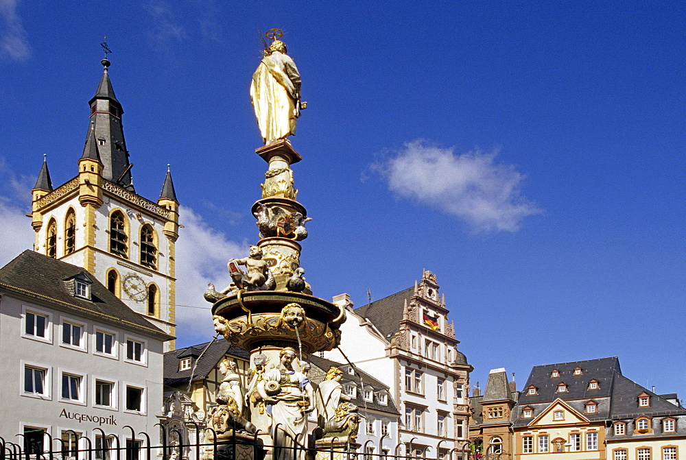 Sculpture on a fountain and houses under blue sky, Trier, Mosel, Rhineland-Palatinate, Germany