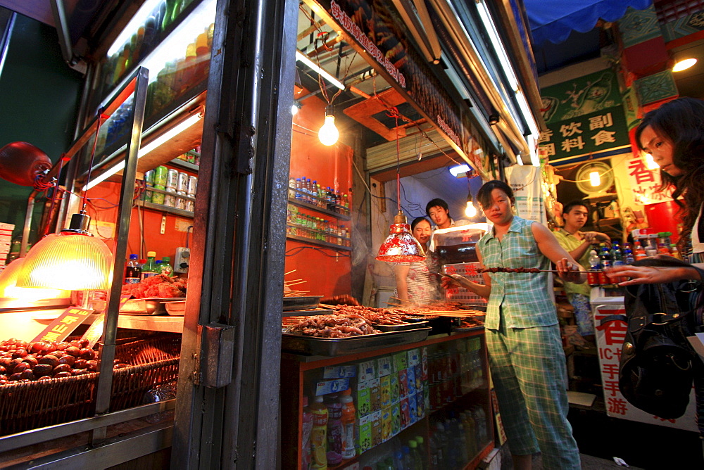 Typical little shop with sales woman in Chongqing, China, Asia