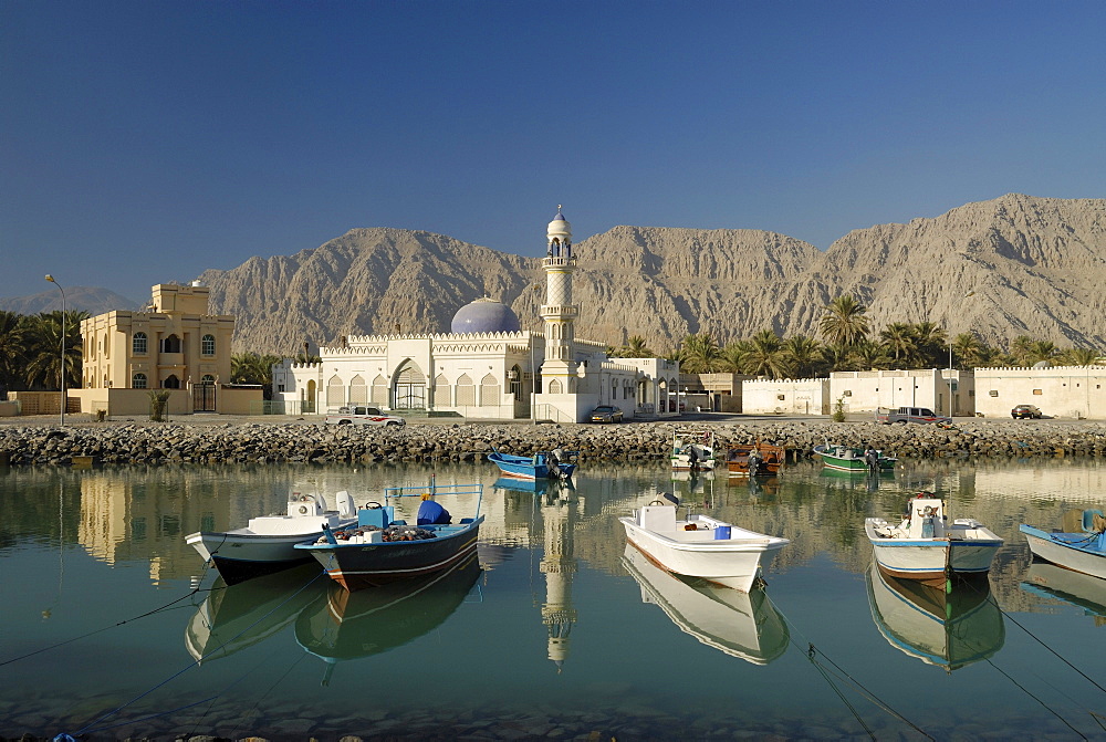 View at a harbour with fishing boats and a mosque in the sunlight, Khasab, Musandam, Oman, Asia