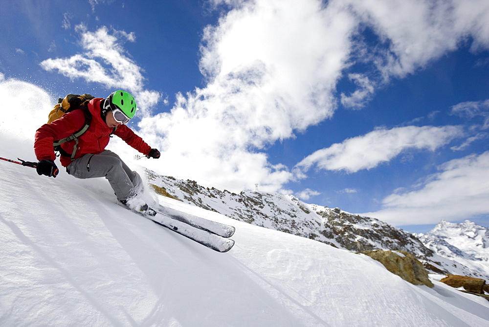 A young man, a skier, a freerider skiing in deep powder on the Stockhorn, Zermatt, Wallis, Valais, Switzerland, MR