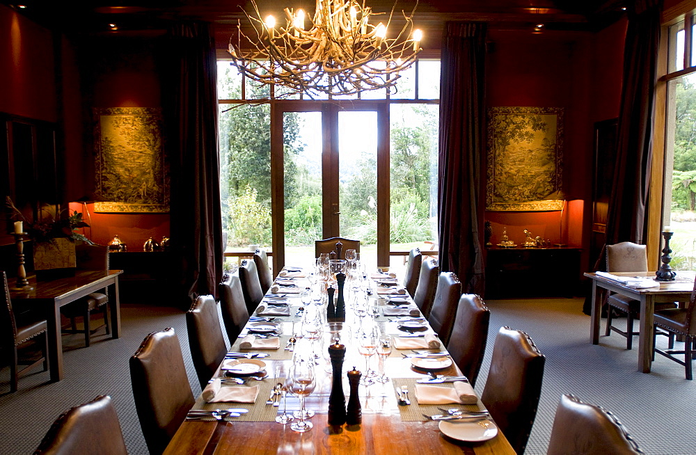 A long table is laid at the deserted dining room of the Treetops Lodge, North Island, New Zealand, Oceania