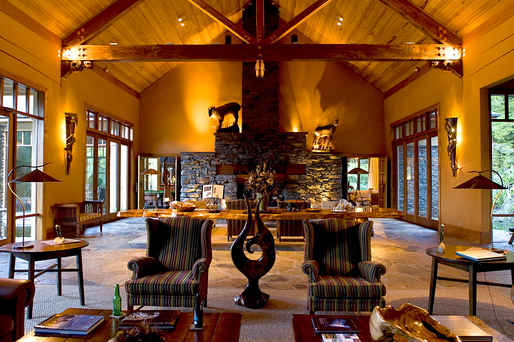 Cosy armchairs standing at the ample lounge of the Treetops Lodge, North Island, New Zealand, Oceania